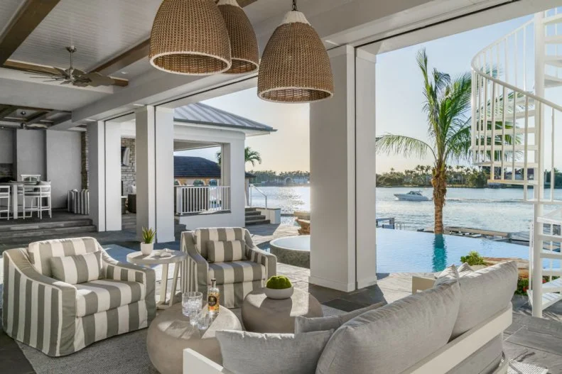 Trio of Wicker Pendant Lights Above Seating Area in Covered Patio