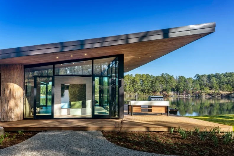 Side View of Neutral Contemporary Lakehouse With Butterfly Roof
