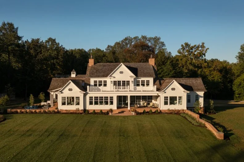 Aerial View of Back of White Cape Cod House and Lawn