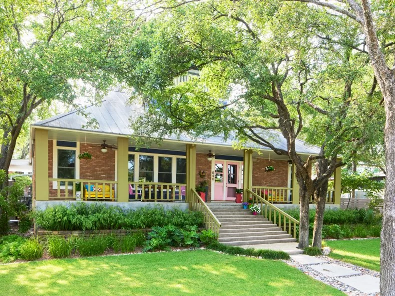 Brick Craftsman-Style House With a Pink Door and Green Trim