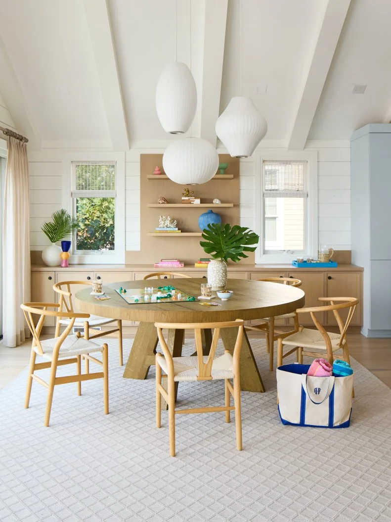 Dining Room With Modern Pendant Lights and Light Wood Wishbone Chairs