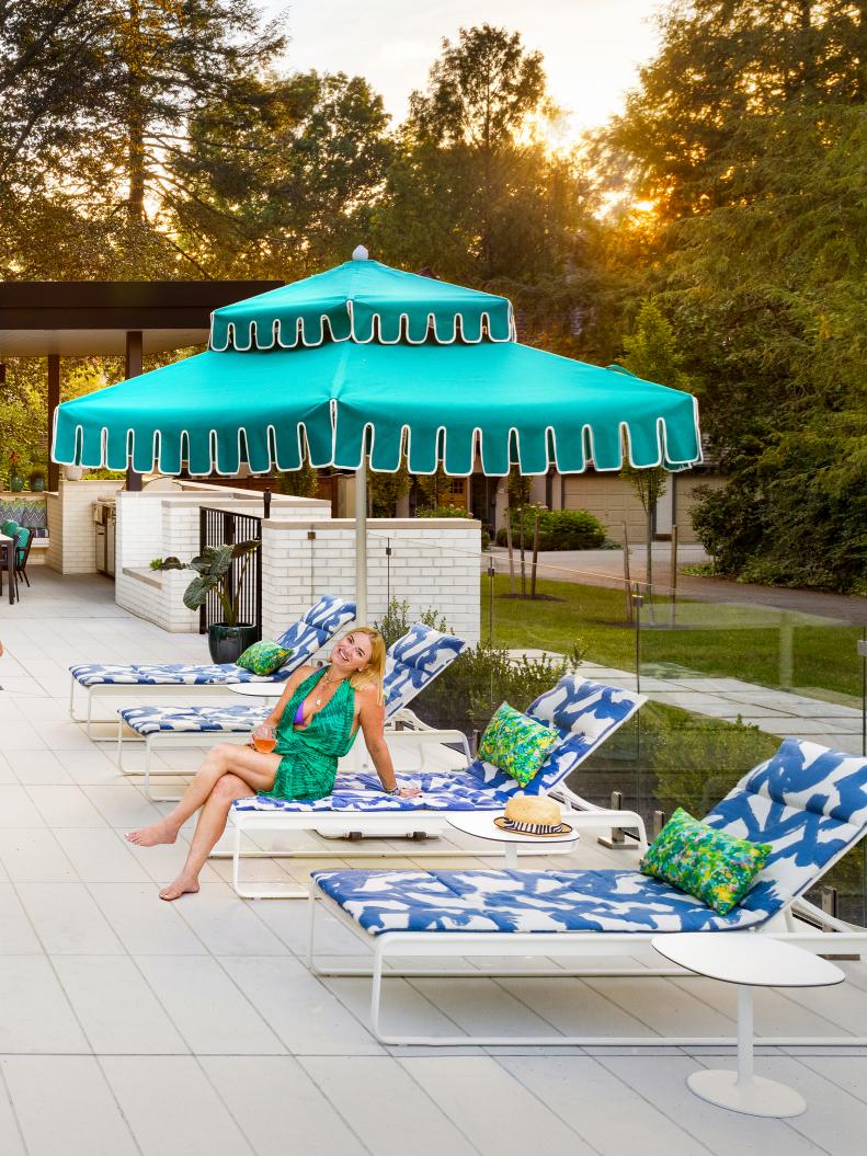 Patio With Teal Umbrella and Patterned Lounge Chairs