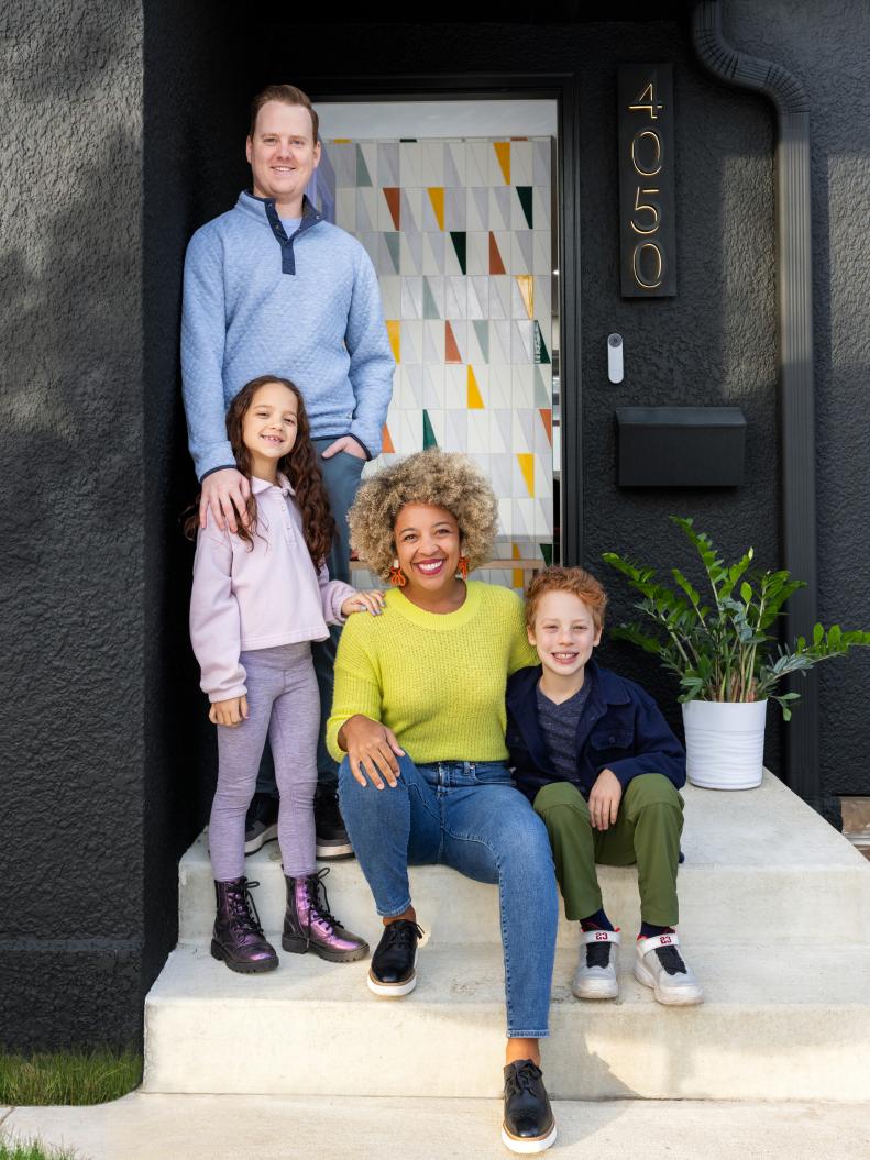 Family Portrait in Front of a Black House With a Mosaic Tile Entry