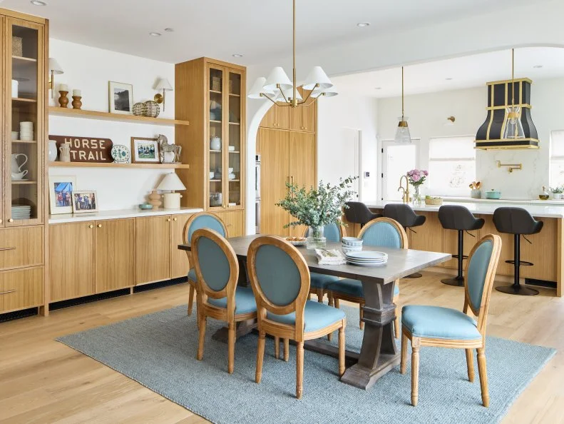 Open-Concept Dining Room With Natural Wood Tones and Teal Chairs