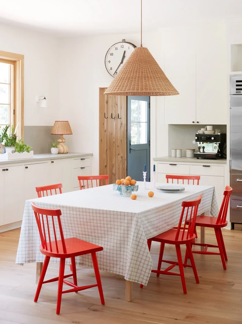 White, Country Kitchen With Natural Wood Accents and Red Dining Chairs