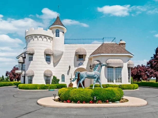 White, Contemporary Castle Residence With a Horse Statue