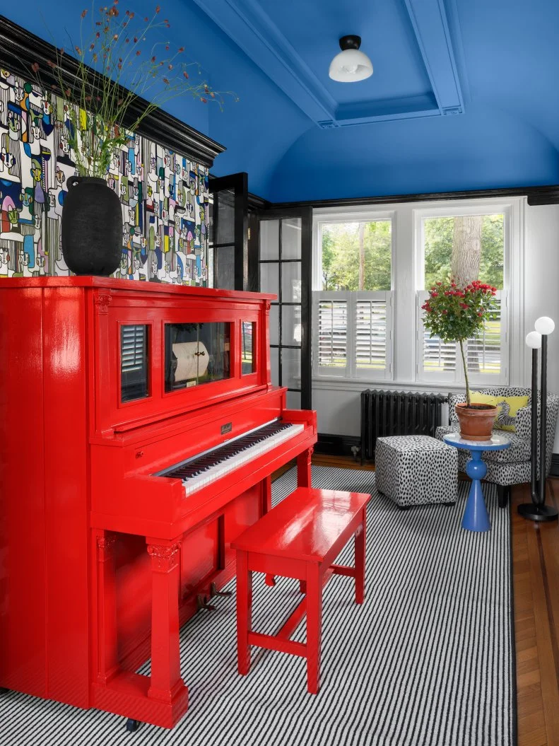 Wallpapered Sunroom With a Blue Ceiling and Red Painted Piano