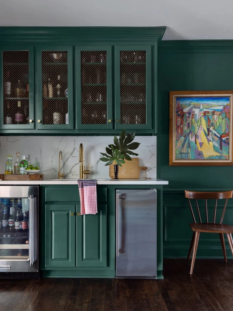 Kitchen With Green Cabinets and Art