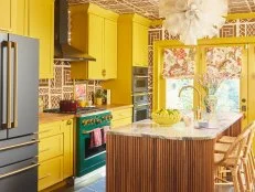 Bold Kitchen With Yellow Cabinets and Wallpaper
