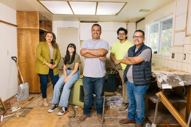 Lilly, Brianna, Izzy, Joe and Rudy Battres pose inside a partially demolished kitchen. 