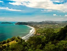 An aerial of the beach and surrounding rainforest and area in Jaco, Costa Rica.