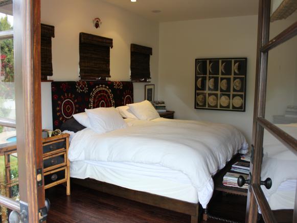 Neutral Spanish-Style Bedroom With Dark Wood Bed