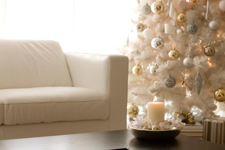 White Christmas Tree Among White Sofa and Brown Coffee Table 