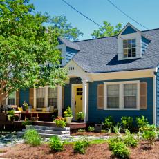 Blue Cape Cod House With Yellow Front Door