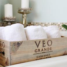 Wooden Wine Crate With Towels, Tile Border and Metallic Candlesticks