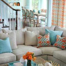 Neutral Sectional With Aqua and Tangerine Throw Pillows
