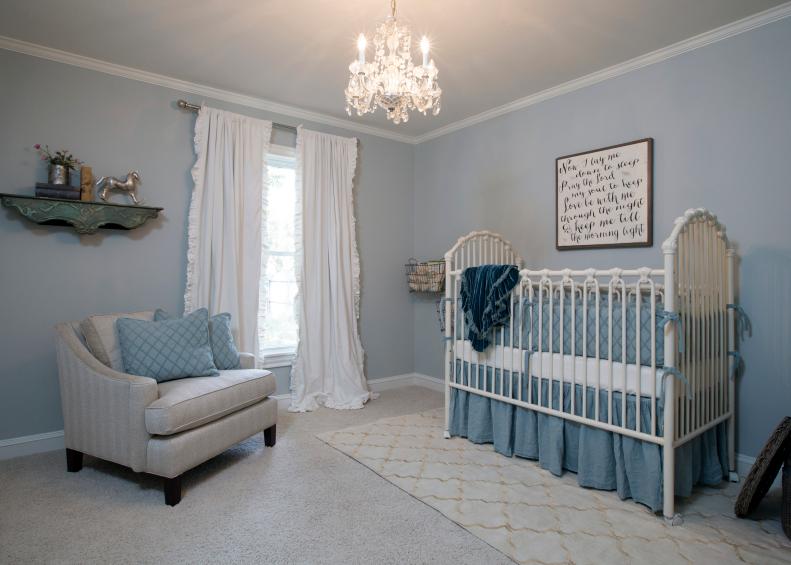 Blue Nursery with White Crib and Gray Chair 