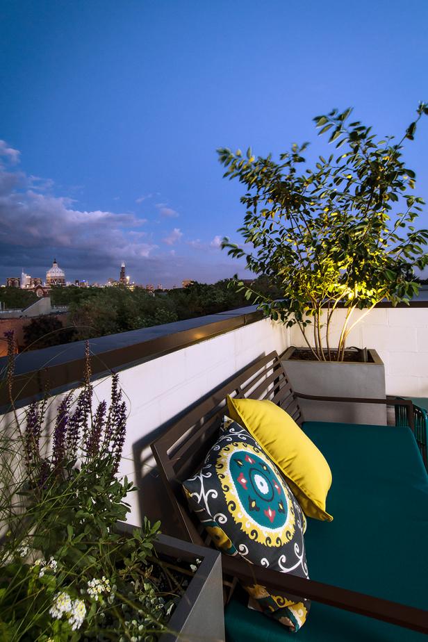 Modern Rooftop With Bench With Bright Patterned Pillows