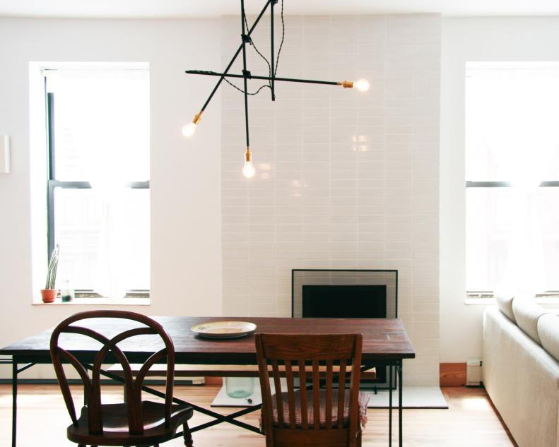 Modern Dining Room with Custom Fireplace and Industrial Chandelier 