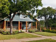 Blue Farmhouse With Natural Wood Fencing