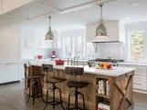 Wondering how to keep an all-white kitchen from looking bland and boring? Simple: Just layer in plenty of natural texture. In this cottage-style space, for example, Jeremy Power of Bella Custom Homes used the center island to add warmth and interest. “We built the island using reclaimed barn wood and topped it with a honed Carrara marble countertop,” he says. The “X” details on each end are a subtle nod to the home’s country roots. 