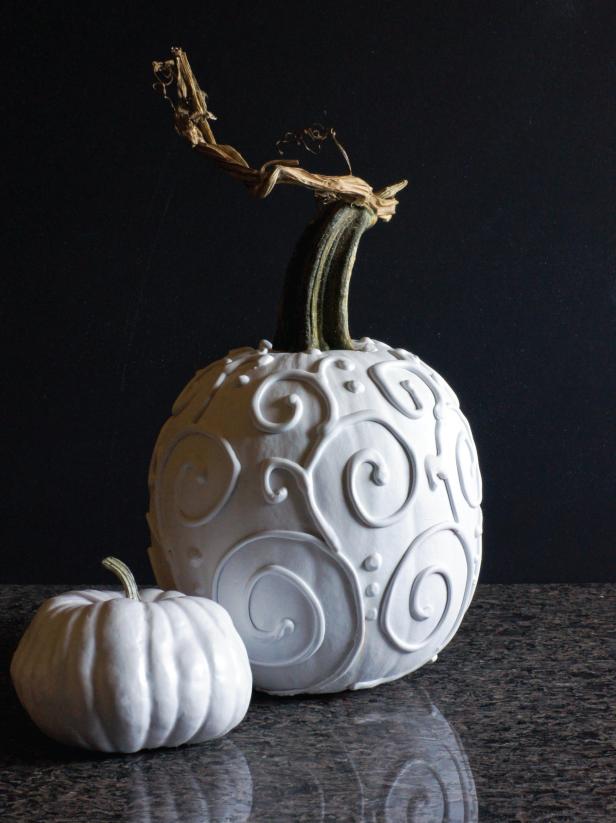 Give your Halloween d&eacute;cor an modern update with this  simple craft project. The materials are inexpensive and easy to find.  The result is stylish and sophisticated. What you’ll need: Pie pumpkin/Silicone caulk/Painter’s tape/Permanent marker/Newsprint/Flat white spray paint