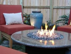 Fire pits are available in many materials, such as this modern use of granite stone and pebbles.