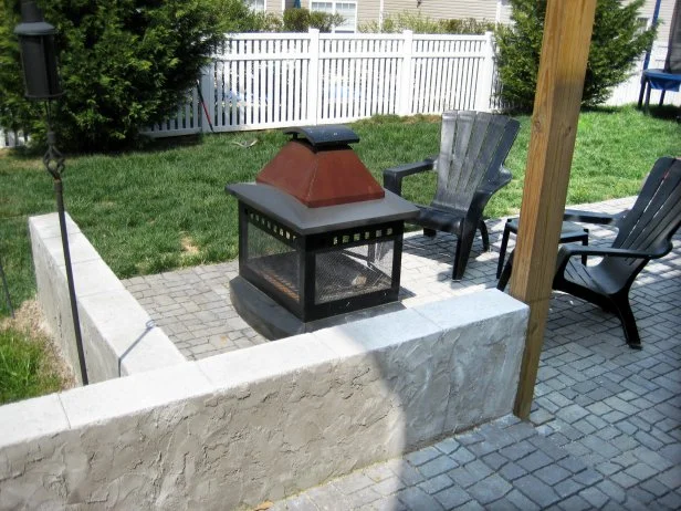 A small prefab and portable outdoor fireplace.