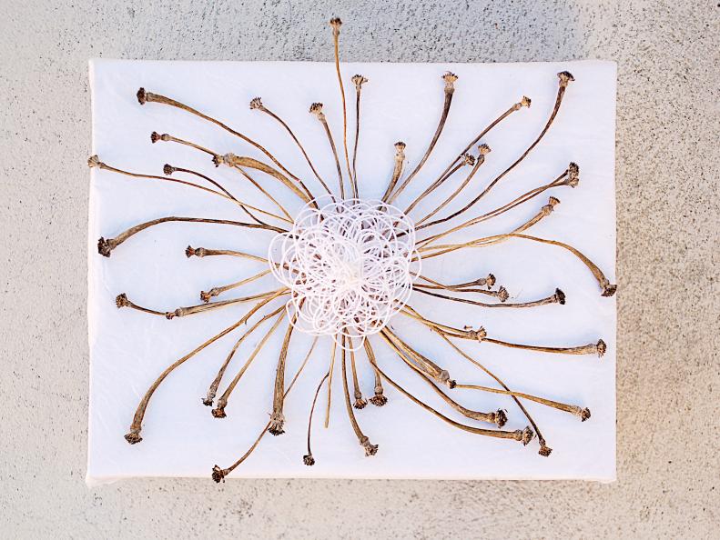 Winter is the perfect time to find dried plants and gift wrapping is a wonderful way to use them! Look for dried stems, twigs or flowers and arrange them in a radiating circle. Glue them together at the center and top with a thread &quot;flower&quot; to add a few soft curves to the stiff lines.