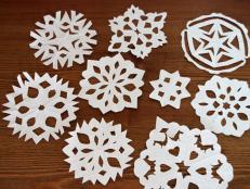 A great winter or Christmas craft to make with kids, you can let it snow inside by creating your very own wintry flurry of snowflakes out of paper.