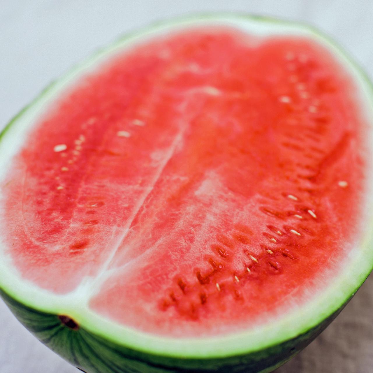 Watermelon the size of an apricot lie together in one hand Stock