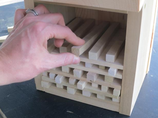 Use a combination of 3/8&quot; and 1/2&quot; inch square dowels, cut to the depth of your box (these are readily available at home building supply stores). Space the dowels evenly apart. A handy trick is to use dowels of the same thickness to get even spacing and then remove them. According to some experts, it helps the pollinators to recognize their own hole from the others if the entrances aren't too uniform, so it can be good to cut some of the dowels a teeny bit shorter while leaving others bit longer, giving a bit of 3-dimensional interest to the front.
