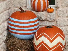 Welcome visitors to your home with a bold arrangement of striped pumpkins. Use painter's tape to keep your lines sharp and clean when painting these.