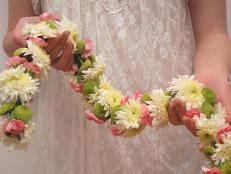Garlands are a perfect and highly versatile addition to your wedding decor. Use them on your wedding arch, drape them over chairs, hang them on tables or over doors and even on your getaway car! This gallery will give show you how to use the same flower to create 3 different garlands, each with a unique look. We have used a white Chrysanthemum for our main flower, however these garlands can be adapted for any kind of flower.