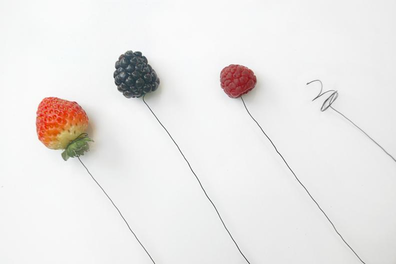 Not all fruits and vegetables will have stems attached, so you will need to create your own to attach them to your bouquet. Use floral wire stiff enough to support the weight of your chosen fruit. Create a spiral on one end and twist gently into the fruit to hold it securely.