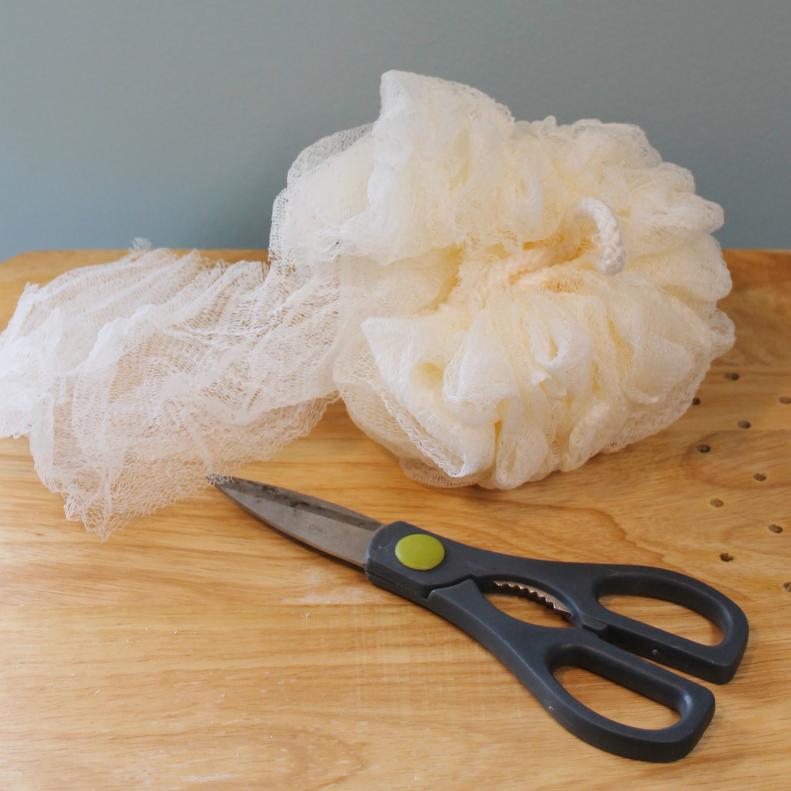 Use scissors to cut the loofah where it bunches together and unravel the material.&nbsp;