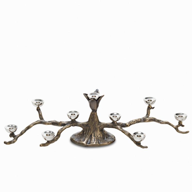 The branches of the <a target="_blank" href="http://maryjurekdesign.com/shop/index.php?main_page=product_info&amp;products_id=31">Odelia Tree Menorah</a> spread out over the table, with simple cups for the candles. The lacquered brass finish shows the natural details of branches.