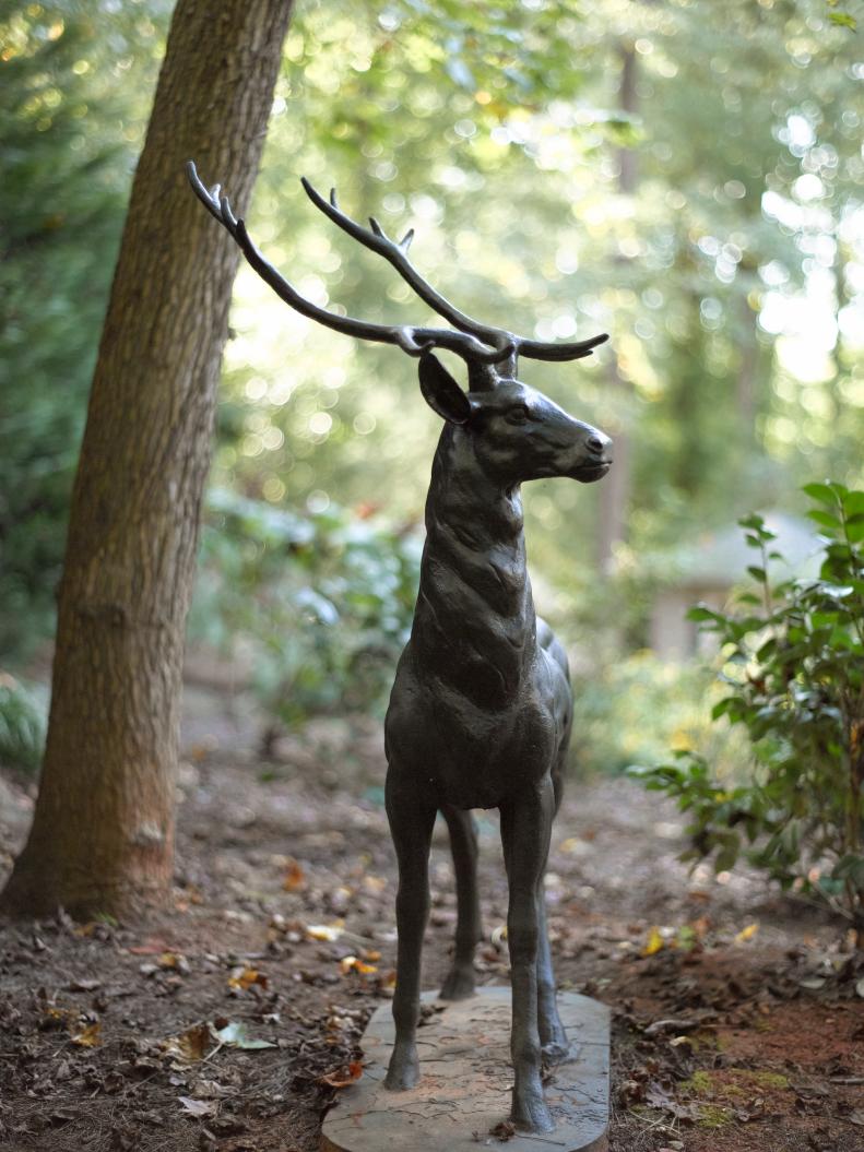 Deer are a common sight in Georgia yards, but this detailed sculpture is a constant fixture in a wooded section of the backyard. The homeowners found the statue at Atlanta's King Galleries, an antique shop and auction house.