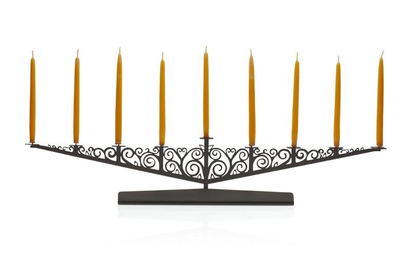 Artist <a target="_blank" href="http://www.valerieatkisson.com/store/">Valerie Atkisson</a> uses a tree of life motif for her menorahs, made of laser-cut steel and plated in oiled bronze, stainless steel or polished steel.