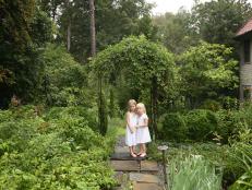 The Georgia garden is a natural place for photographer Angela West to catch daughters Lila (left) and Caroline Harris through her lens. The girls are surrounded by plants including purple coneflowers, roses and English boxwood.