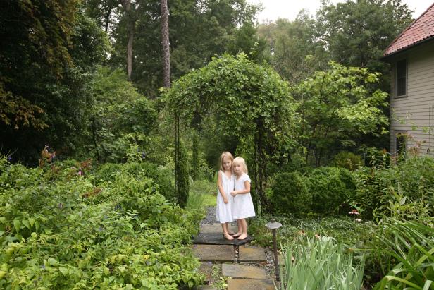 The Georgia garden is a natural place for photographer Angela West to catch daughters Lila (left) and Caroline Harris through her lens. The girls are surrounded by plants including purple coneflowers, roses and English boxwood.