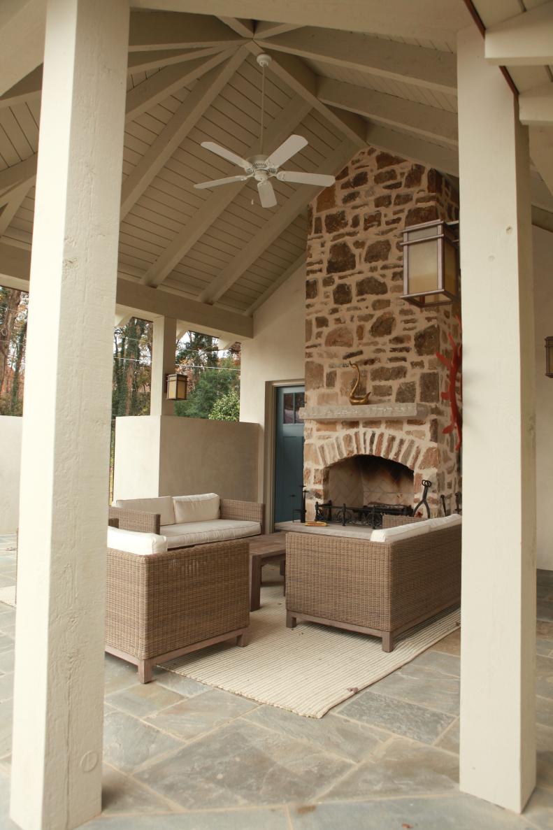 When adding an outdoor living room, think about the statement you want to make. The vaulted ceiling and floor-to-ceiling stone fireplace make a stunning addition to a yard in a historic Atlanta subdivision.