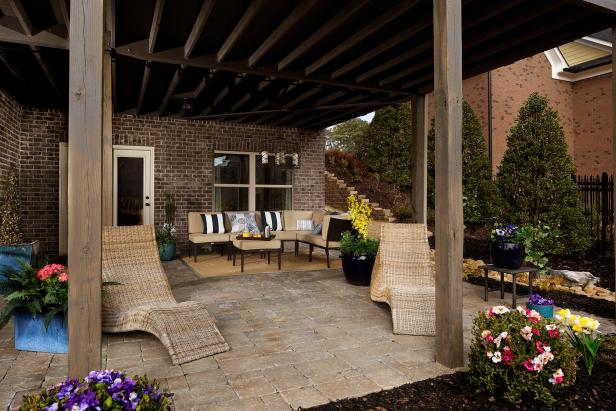 Expanding the size of the patio can allow you to fit in different types of seating and planters to bring the flowers to you and your guests.