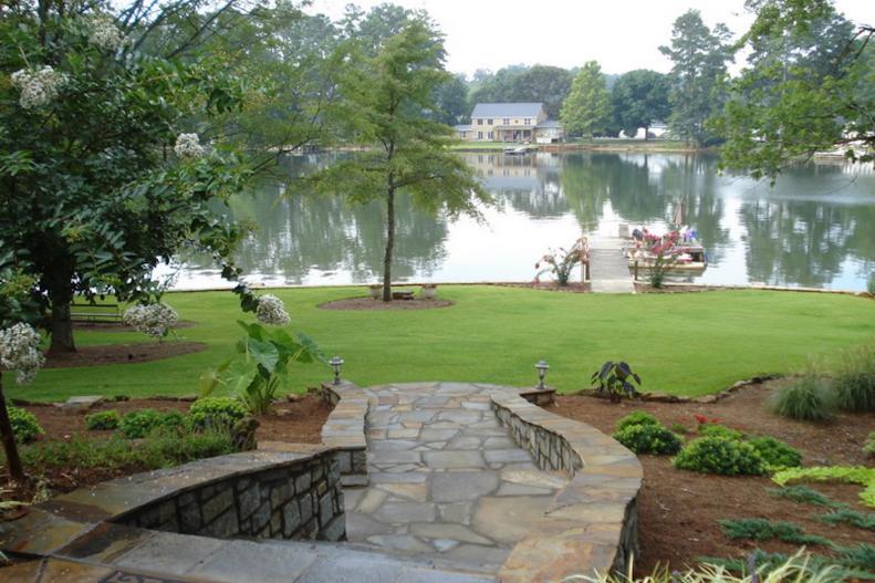 Georgia's Jackson Lake may be the focal point of this property, but the stone steps and mulched beds outlined in stone beautify the space.