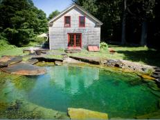 A pond pool by <a target="_blank" href="http://www.waterhousepools.com/projects/">Waterhouse Pools and Ponds</a> at this upscale rustic residence features a  “sunken patio&quot; floor and a floating stone diving platform. A  gutter system for collecting rainwater is built into the cedar deck,  while a low-flowing water feature minimizes evaporation.