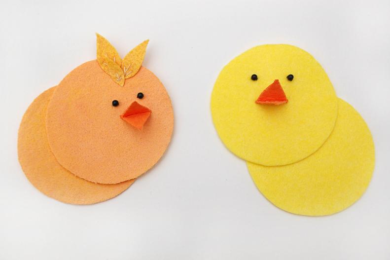 Fold the diamond in half to create your chick's beak. Glue or stitch along the fold to attach the beak to the circle. You can add eyes to your chick with a couple of beads and if you want to give him a little more personality you can attach a few feather shapes cut from felt.