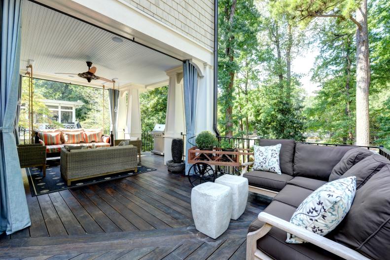 By combining an open air porch with a covered one, you can enjoy the best of both environments as seen in this striking multi-purpose set up that allows for formal and informal gatherings. A wide array of lounging options are strategically arranged around the handsome Ipe wood flooring.