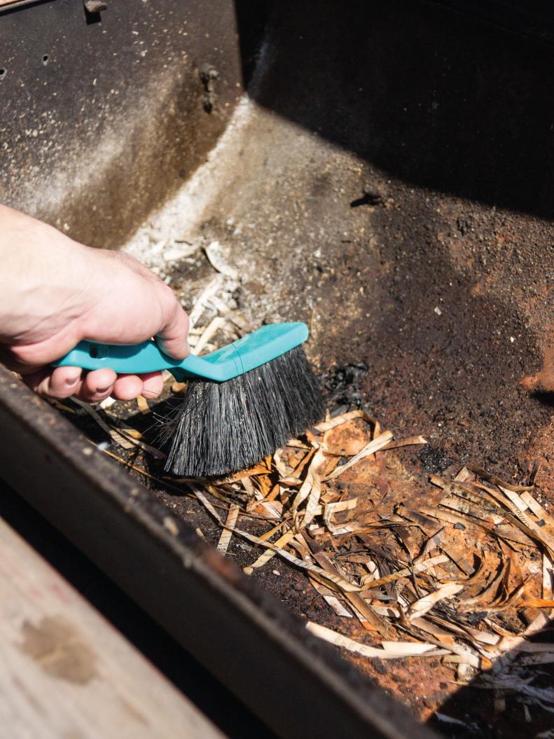 Remove any debris from the charcoal basin and sand lightly to remove any rust.