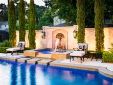 This stunning combination of swimming pool and spa by Pool Environments is distinguished by the wall fountain with its distinctive laser cut steel sculpture mounted on a seven foot limestone and cast stone wall.&nbsp;