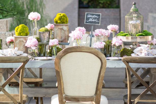“My look is very Parisian,” says designer James Hurley, who incorporated a zinc-top table, vintage bottles, boxes crafted of reclaimed wood, and aluminum canisters in the tablescape. “I wanted it to look effortless but also look like it took a while,” he jokes.&nbsp;